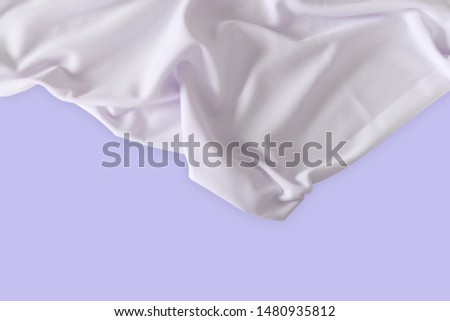 White polyester fabric wave with copy space on purple pastel background.