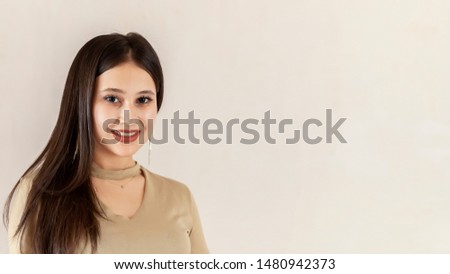 Portrait of a beautiful middle-eastern girl. Young attractive female looking into the camera and smiling. Charming, pretty posing cheerfully. Copy space