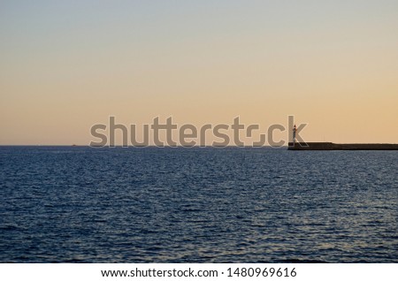 Lighthouse on the horizon  line between the sea and the sky, Almería, Spain