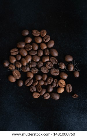 Large photo of coffee beans on a black background