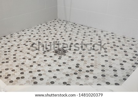 Penny round mosaic glass tiles design in shower of bathroom. Royalty-Free Stock Photo #1481020379
