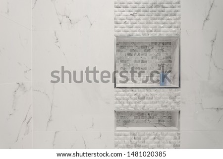 Shampoo and conditioner or shower gel bottles in a rectangular niche made of white mosaic tiles in shower and bathroom. White and blue shampoo bottles Royalty-Free Stock Photo #1481020385