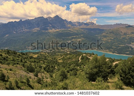 View of the Valley of Tena. Two reservoirs of turquoise water, mountains in background and clouds in the top