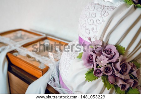 Detail of wedding cake and two icons, blur