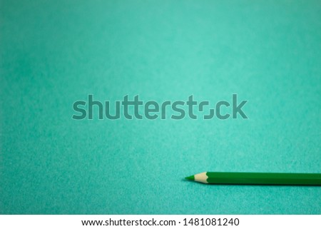 Template with copy space by top view photo of wooden green pencil color put on green paper 