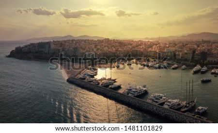 Aerial drone photo of iconic round port of and Marina of Zea or Pasa Limani at sunset with beautiful golden colours and cloudy clear sky, Piraeus, Attica, Greece