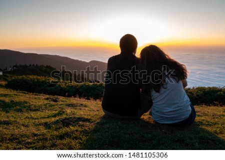 Couple looking at the beautiful sunset from Gomismta mountain, Georgia. Travel.