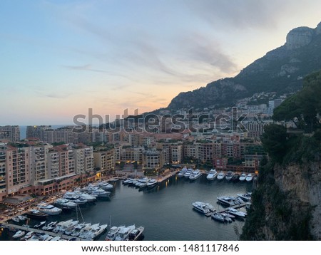 Monaco City, Monaco - August 2 2019: Views from above the princes palace with yachts and sunset three countries italy france in one picture incredible sky and mountains