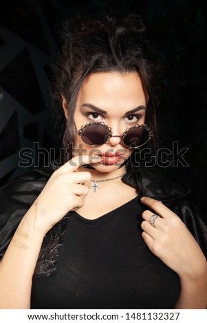 Beautiful goth fashion stylish girl on black studio background