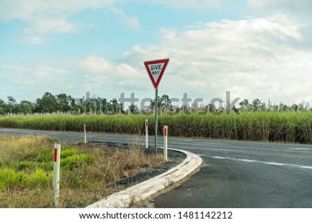 Give way sign to car driver when entering the highway at a rural intersection