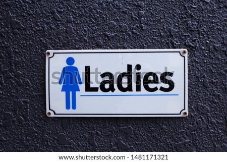 Toilet signboard on the wall background