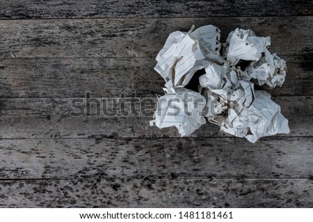Unavailable design work  And crumpled the paper, resting on the gray wooden floor