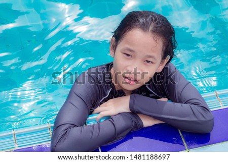 asian cute children girl in swimming pool at thailand