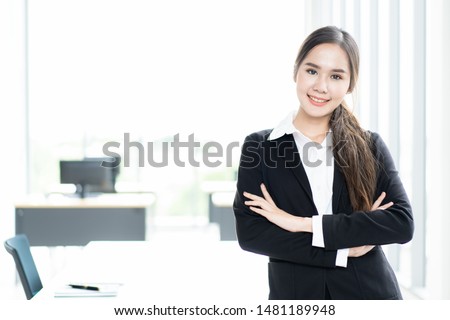 Portrait of beautiful and good looking Asian businesswoman in formal suit in office close up.   Modern and professional team concept.