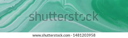 photography of abstract marbleized effect background. emerald, green, mint and white creative colors. Beautiful paint. banner