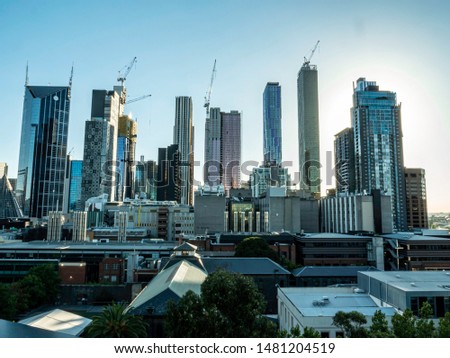 View of Melbourne, Australia buildings during sunset. Trademarks removed, no people.  Royalty-Free Stock Photo #1481204519