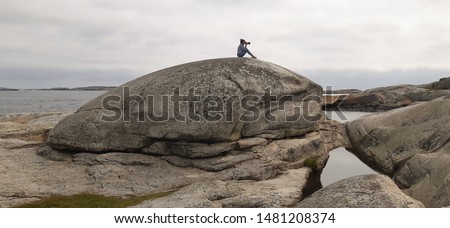 Woman photograph  in The End of the Earth in Norway. Verdens Ende (World's End) is composed of various islets and rocks and is a popular recreational area with fantastic panoramic views. 
