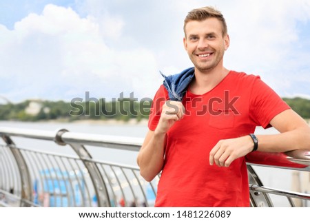 Portrait of handsome standing on bridge