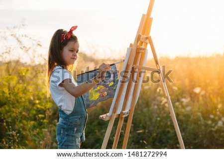 education, school, art and painitng concept - little student girl painting picture