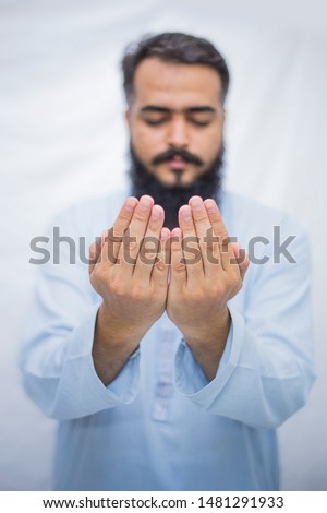 Religious muslim man praying light background - Image