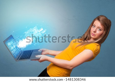 Woman holding laptop projecting notifications, symbols and information based on cloud technology system