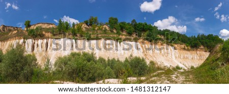 Beautiful sunny summer panorama of forests and blue sky. Horizontal color photography.