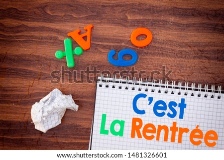 back to school translated in french concept,  notebook, numbers and letter  on wood table 