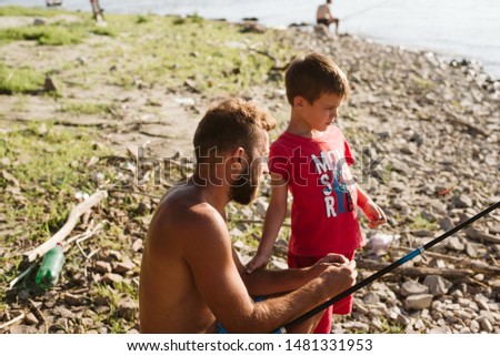 The son and father are fishing on a beautiful sunny day