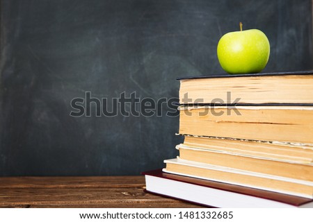 Green apple over pile of books for shool concept. Education concept, toned and soft focus image