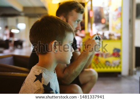 Father and son plays digital games