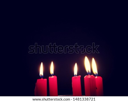 Close Up of Five Christmas Candles on Dark Background 