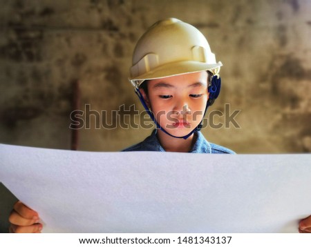 A boy photo in engineering style with safety helmet and a jean jacket.