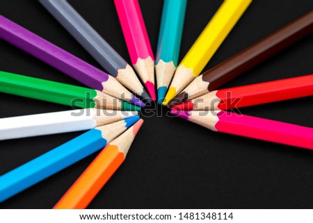 Colored pencils isolated on black background. Close up