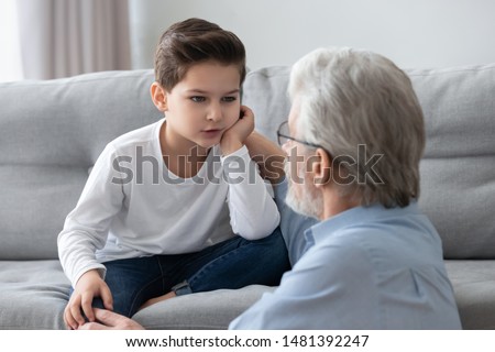 Grandfather and little grandson having heart to heart talk at home, spending time together good warm relations understanding, grandad not indifferent to problems of grandchild, trust and care concept Royalty-Free Stock Photo #1481392247