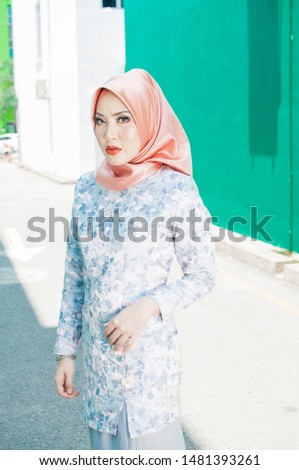 Portraiture of beautiful Muslim female model wearing hijab and casual dress indoor.Hijab fashion for muslim's female.