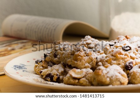 plate of christmas cookies with book in the background