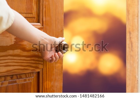 Women hand opens door Close up hand open door.