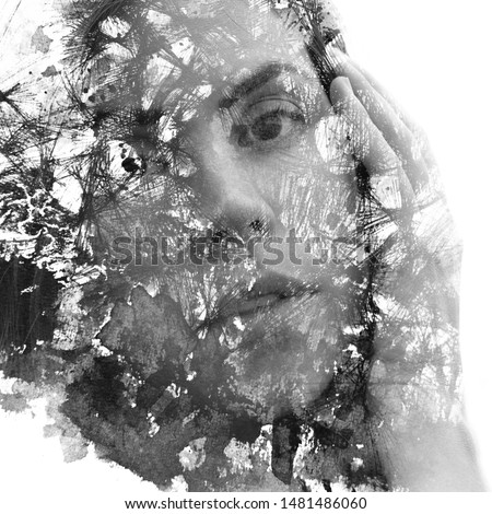 Paintography. Double exposure. Young girl with hand on face disappears behind hand made ink and pen drawing with lines and shapes dissolving into her face. Black and white