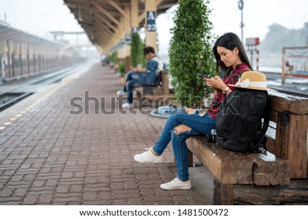 Tourists waiting for the train at the chair to travel