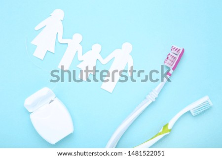 Family figures with toothbrushes on blue background