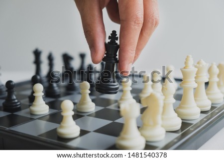 hand holding chess pieces on board with white background, driven to success Business Strategy.