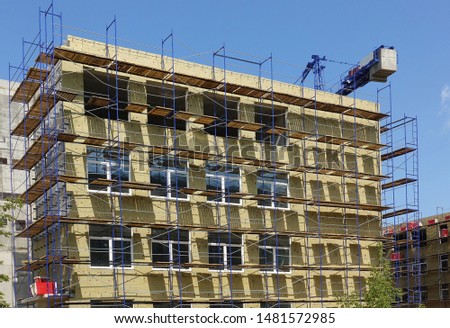 Solid wall insulation with rock wool. Energy efficiency house wall renovation for energy saving. Exterior house wall heat insulation with mineral wool. External wall insulation. Royalty-Free Stock Photo #1481572985