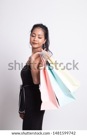 Young Asian woman happy with shopping bag on white background