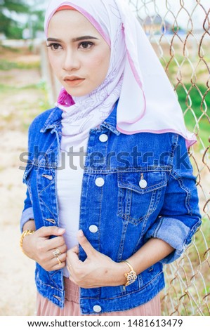 Beautiful muslim women wearing hijab on forged door background