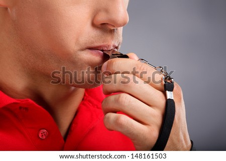 Whistle. Man blowing a whistle Royalty-Free Stock Photo #148161503