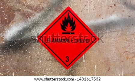 pictogram for chemical hazard: flammable liquids. Hazard warning sign on rusty metal