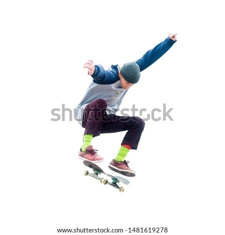 Teenager skateboarder jumps ollie on an isolated white background. The concept of street sports and urban culture