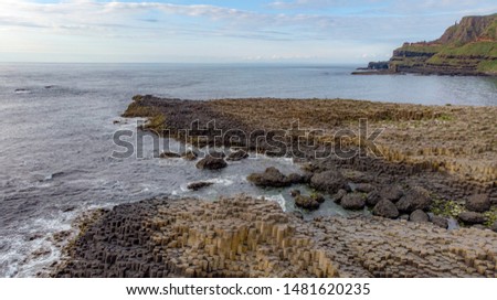 Geometric rock formation landscape at the Giant’s Causeway, taken by drone. Northern Ireland. World Heritage by UNESCO