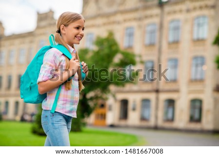 Profile side photo of cheerful kid going to school wearing checkered plaid shirt denim jeans outside