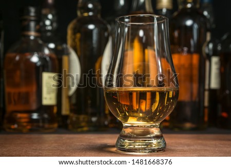 Scotch whisky in a traditional tasting glass. Royalty-Free Stock Photo #1481668376
